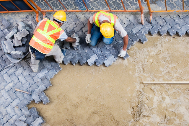 Construction workers fixing pavement