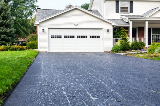 New Asphalt Driveway Rain Puddles at Residential Home